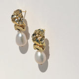 Gold crushed metal stud and pearl drop earring.