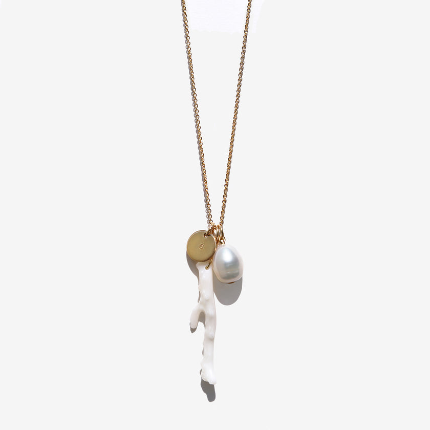Initial necklace with white coral and pearl.