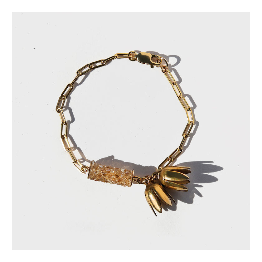 Gold paperclip chain bracelet with flower charms