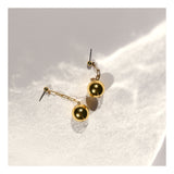 Paperclip chain gold ball drop earrings.