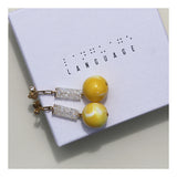 Dangle earrings with yellow orb and crystal tube.