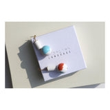 White column and marbled orb drop earrings.