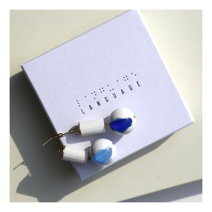White lucite column blue orb earrings.