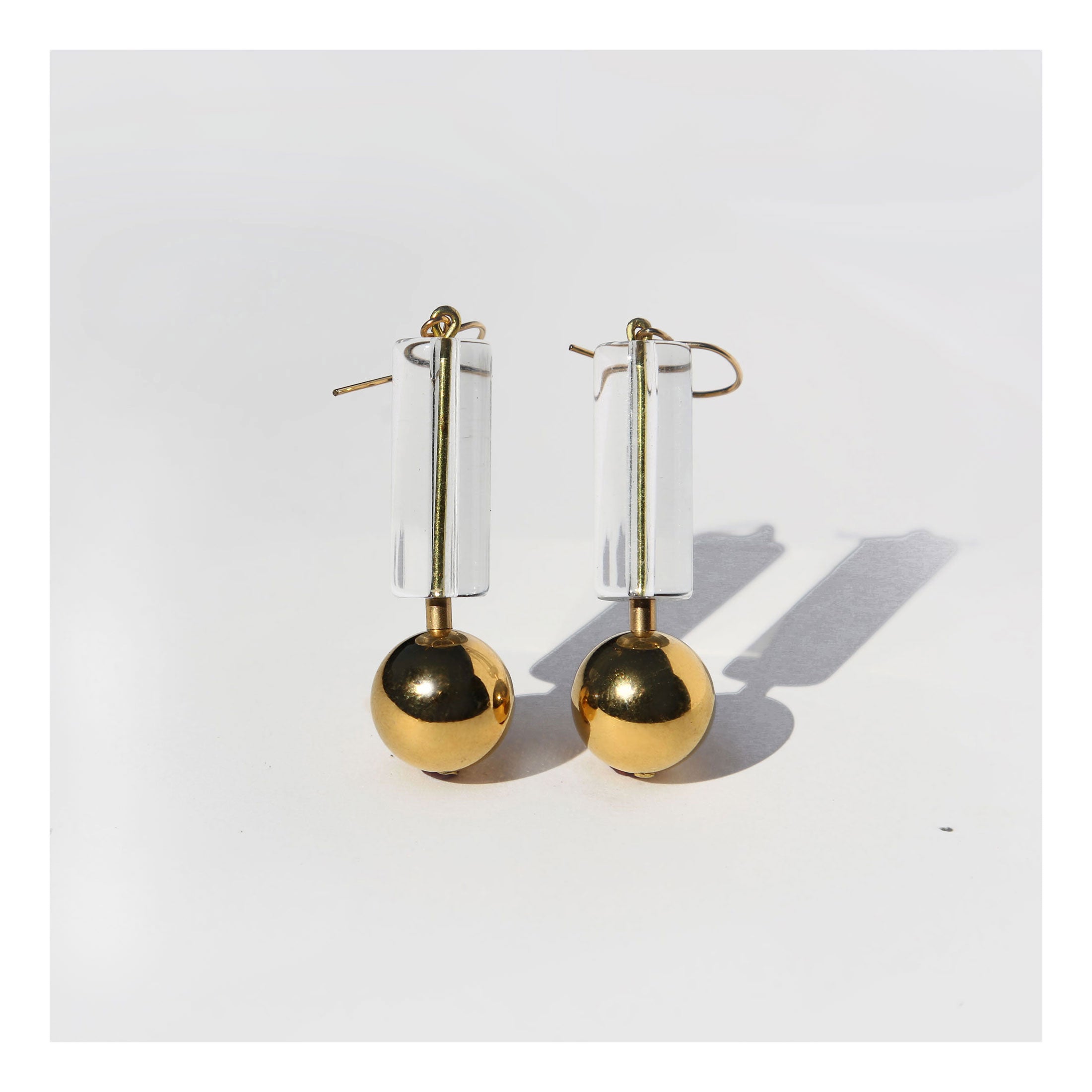 Mid century Lucite tube and gold ball drop earrings.